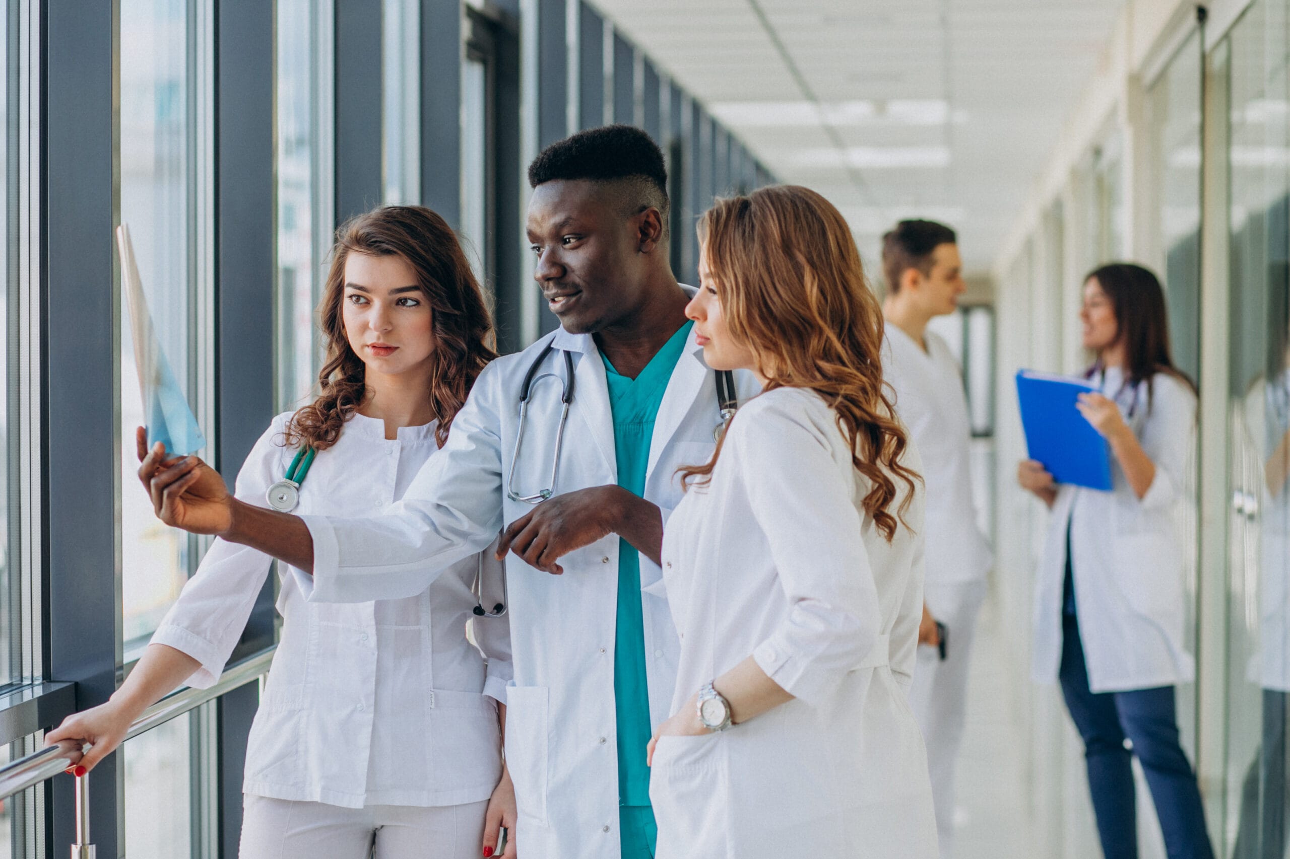 team of young specialist doctors standing in the corridor of the hospital scaled