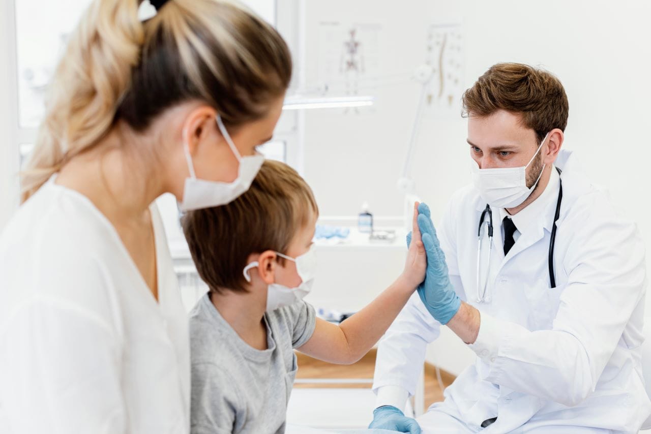 close up patient and doctor high five